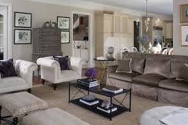 brown sofa with white accent chairs