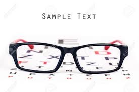 Black And Red Reading Glasses Kept Over Black And Red Eye Chart