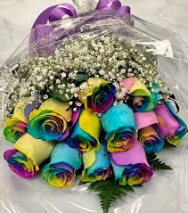 dozen rainbow roses in a presentation