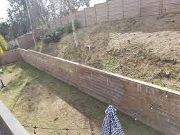 unattractive retaining wall and slope