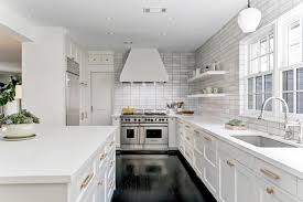 Choose glossy white cabinets and countertops with an integrated sink to contrast with black stainless steel appliances. Modern White Kitchen With Stainless Steel Appliances And Gold Hardware Hgtv