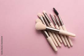 set of makeup brushes on soft pink