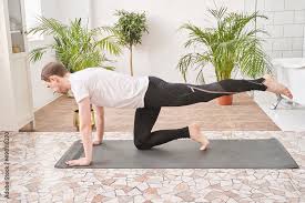 man doing yoga exercise at home