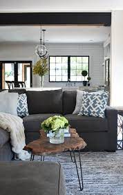 black sectional with blue pillows