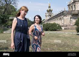 Dresden, Germany. 26th Aug, 2019. Federal chairwoman Annalena Baerbock (r)  and Katja Meier, top candidate of Bündnis 90/Die Grünen for the state  elections, will walk along the edge of a closed meeting