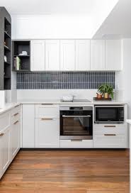35 white cabinets with dark backsplash