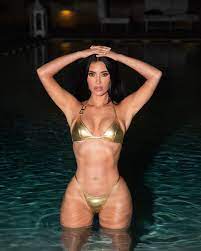 Kim Kardashian bikes in a gold bikini in sexy 'night swim' snaps
