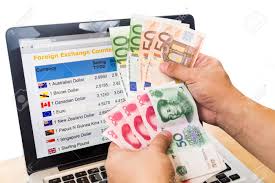 Hand Sorting Euro And Yuan In Front Of Currency Exchange Chart