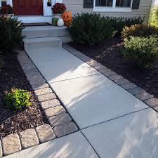 Adding Pavers Around A Standard Concrete Walkway Can Give