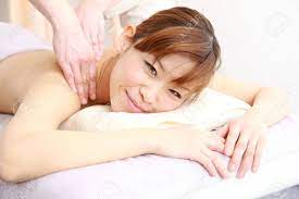 Young Japanese Woman Getting A Back Massage Stock Photo, Picture and  Royalty Free Image. Image 32771000.