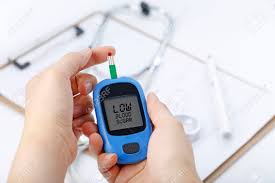 Hand Holding A Blood Glucose Meter Measuring Blood Sugar The