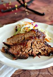 oven cooked barbecue brisket slices on a white plate