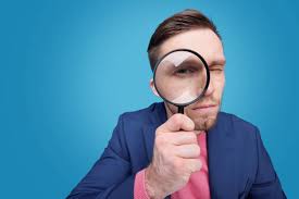 Serious Young Male Detective Holding Magnifying Glass By Right Eye Stock  Photo - Download Image Now - iStock
