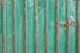 Pattern Of Rust On The Green Wall Metal