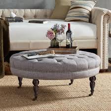Perfect for use as an ottoman or coffee table, the piece has a tufted top upholstered in a charcoal linen fabric. Homelegance E208rd Traditional Round Tufted Bench Ottoman With Casters Value City Furniture Ottomans