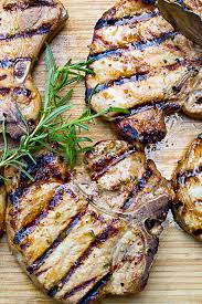 marinated pork chops on the grill two