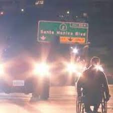 man in a wheelchair on the 405 highway