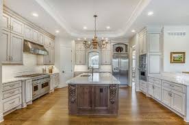 Image © luxe classic kitchens & interiors, inc. Luxury Kitchen With Antique White Cabinets Carrara Marble Counter Island And Walnu Antique White Kitchen Antique White Cabinets Antique White Kitchen Cabinets