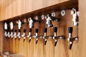 Chrome Beer Taps In A Row On Wooden