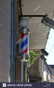 Traditional Barber Shop Sign Stripped Hanging On Wall Outside Stock Photo Alamy