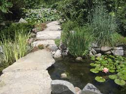 A Stone Bridge Over The Pond At