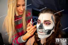 makeup artist puts face painting of a