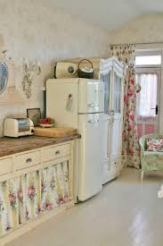 What a great farmhouse cabinet! Hard Not To Picture A Sweet Little Rose Cottage Here Floral Curtains Armoire In The Shabby Chic Kitchen Decor Shabby Chic Kitchen Cabinets Chic Kitchen Decor