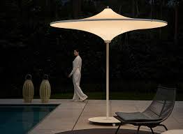 Sun Umbrella By Day And An Outdoor Lamp