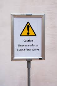 caution uneven surfaces during floor