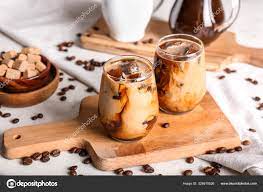 gles of tasty cold coffee on table