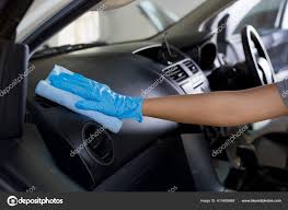 hand wearing rubber gloves clean car