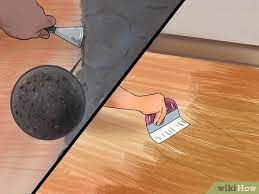 remove adhesive on hardwood floor