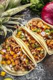 What is the difference between carnitas and al pastor tacos?