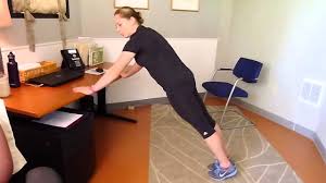 woman doing desk push ups at work