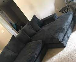 dark tan walls with a dark gray couch