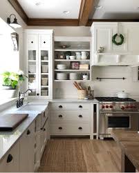 Brown Crown Moulding And Beams In White Kitchen With Black