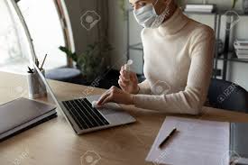 Then, dampen your cloth with alcohol. Female Employee Sit In Office Wear Protective Face Mask Disinfect Computer With Antibacterial Liquid Gel Protect From Coronavirus Woman Sanitize Laptop Workplace With Sanitizer From Covid 19 Pandemic Stock Photo Picture And Royalty