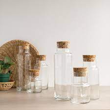 three vintage glass jars with cork tops
