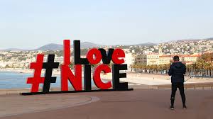 the i love nice sign and blue chairs