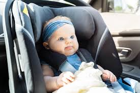 Baby Girl Sitting In An Infant Car Seat