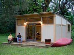 The hiatus home includes a small attached 'garage' space for bikes, camping equipment, etc. Small House Kits Michaelhowellsstudio