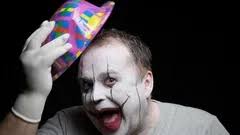 cheerful clown with terrible makeup on