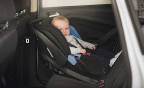 Old Baby Boy Sitting In Child Car Seat