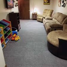 When measuring a room for carpet tiles, use a tape measure to determine the distance between baseboards. Basement Modular Carpet Tiles With A Raised Lock Together Base