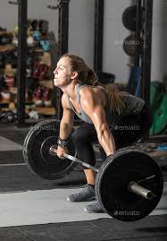 strong young female weight lifter doing