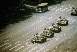 Protesters attempt to stop a burning armoured personnel carrier on changan boulevard in the early morning of june 4, 1989. The Tank Man Iconic Photos