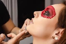 makeup artist gluing accessories