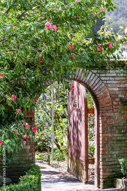 Arched Red Wooden Garden Gate In A
