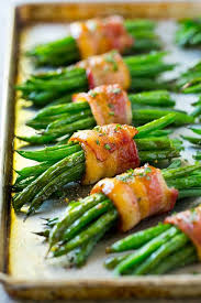Veggies alone are great for you, but sometimes they need just that little extra something. A Row Of Green Bean Bundles On A Pan Thanksgiving Recipes Side Dishes Best Thanksgiving Side Dishes Thanksgiving Food Sides