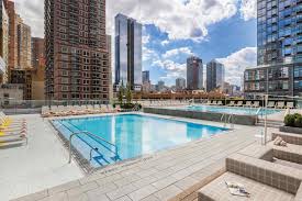 a photograph of rooftop pool area of the life time sky manhattan